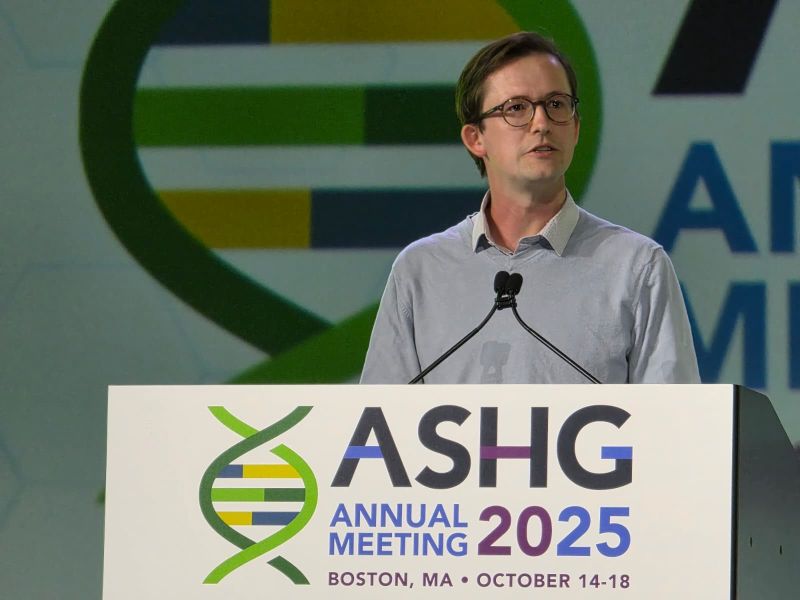Riley Mangan presenting a platform talk at ASHG 2025
